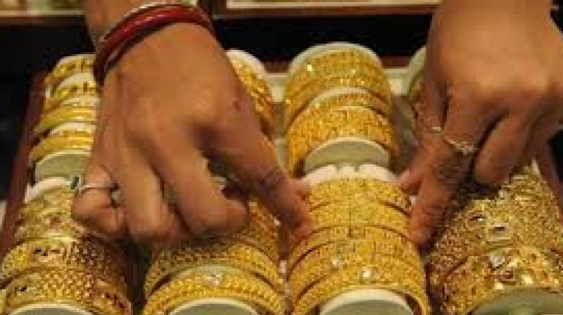 Spot gold was down 0.3 per cent at USD 1,212.50 an ounce in early trade.