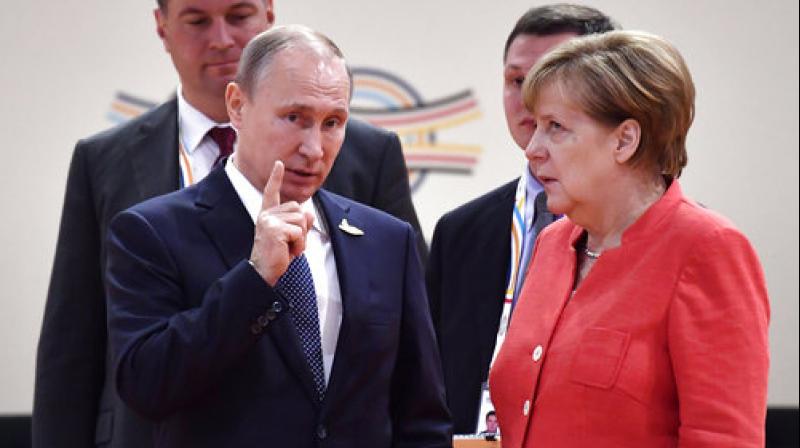 G20 summit: Exasperated Merkel makes eye-roll during chat with Putin
