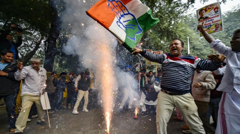 Congress Party workers celebrate the party victory in the states Assembly elections, at the Congress headquarters in New Delhi. (Photo: PTI)