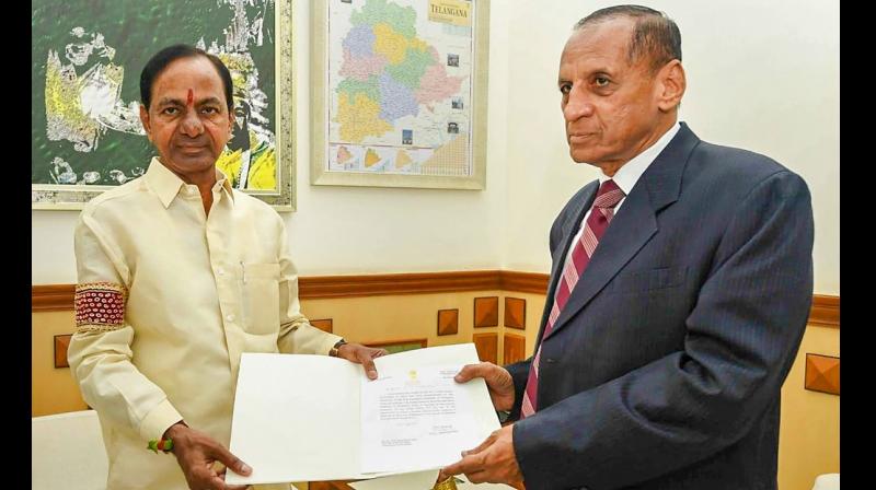 Telangana Chief Minister K Chandrashekhar Rao submits to Governor ESL Narsimhan his governments recommendation for dissolving the Assembly, and his resignation as chief minister, in Hyderabad. (Photo: PTI)