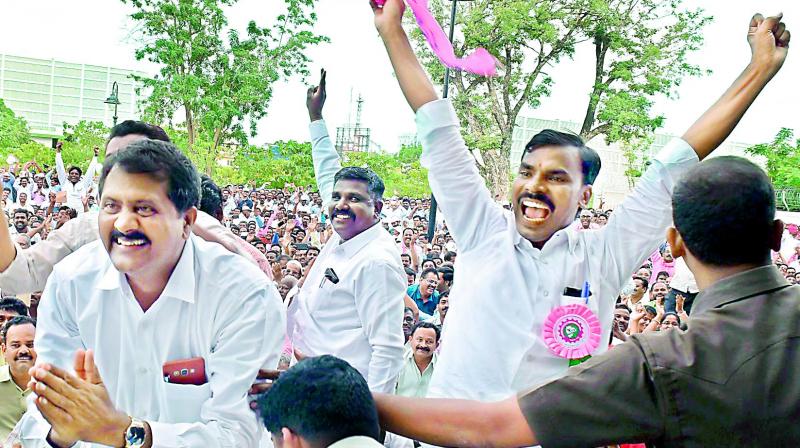 Employees of power companies cheer as Chief Minister K. Chandrasekhar Rao announces sops for them at a meeting organised in Pragathi Bhavan in Hyderabad on Saturday.
