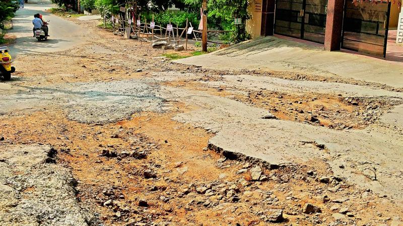 Pothole-ridden road at Kalajyothi has been neglected for last two years.  (Photo:DC)