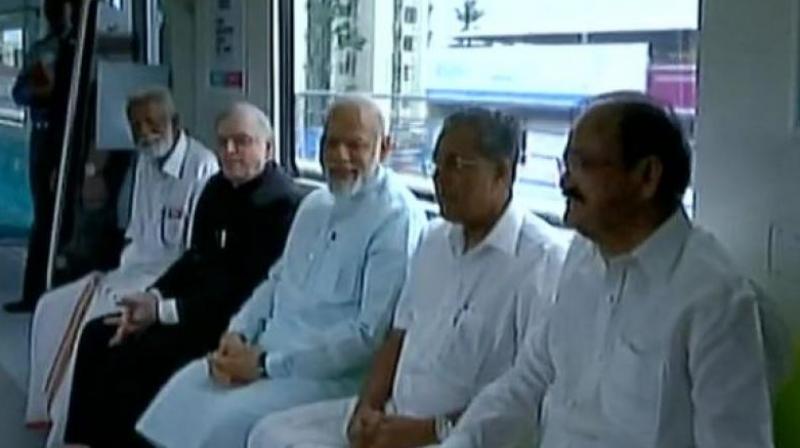 PM Narendra Modi takes a ride in Kochi Metro with CM Pinarayi Vijayan, V Naidu and E Sreedharan. (Photo: ANI/Twitter)
