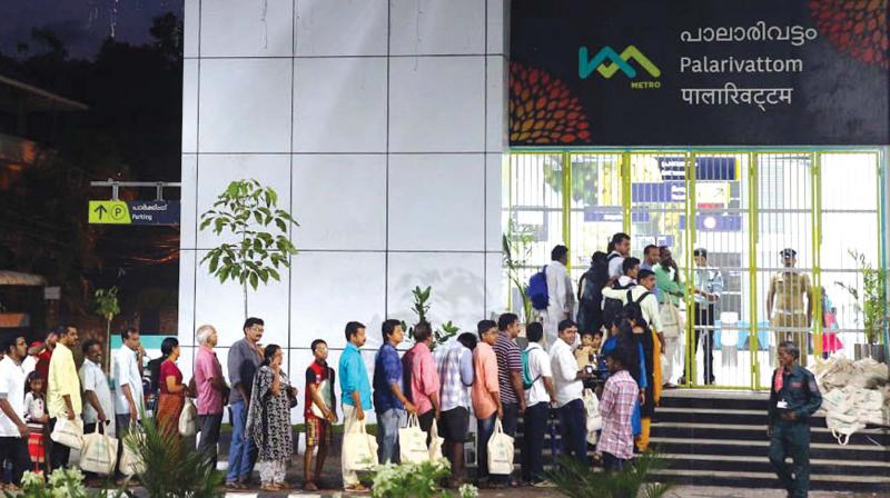 People queue up in front of Palarivattom Metro rail station in the small hours as the facility began commercial operations on Monday. (Photo: Arunchandra Bose)