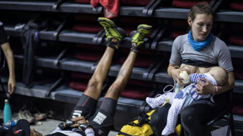 Great-Britains trail runner Sophie Power breastfeeds her three months old baby Cormac. (Photo: AFP)