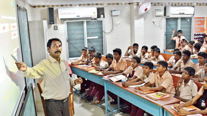 A teacher from Chennai high school, Kodungaiyur,  uses a smart screen on Tuesday.	(Photo: DC)