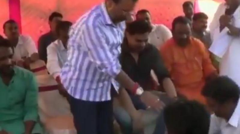 In the video, a BJP worker, Pawan, can be seen washing Dubeys feet and drinking the water used for it. (Photo: Screengrab | ANI)