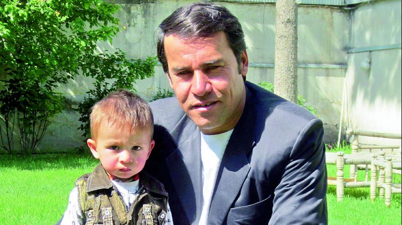 AFP photographer Shah Marai posing for a picture with one of his young sons, in Kabul in 2013. Marai, AFP chief photographer who was killed in the suicide bombing on Monday, was a courageous journalist reporting on the conflict.  (Photo:AFP)