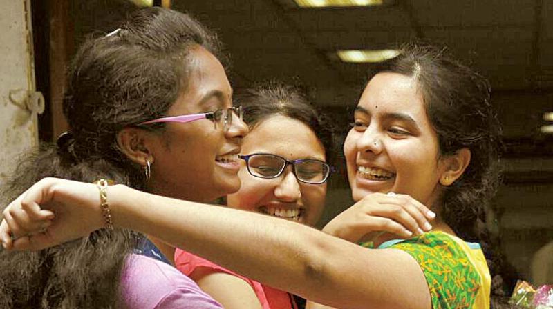 Commerce topper Amrutha S.R. celebrates with her friends after the results were announced in Bengaluru on Monday.