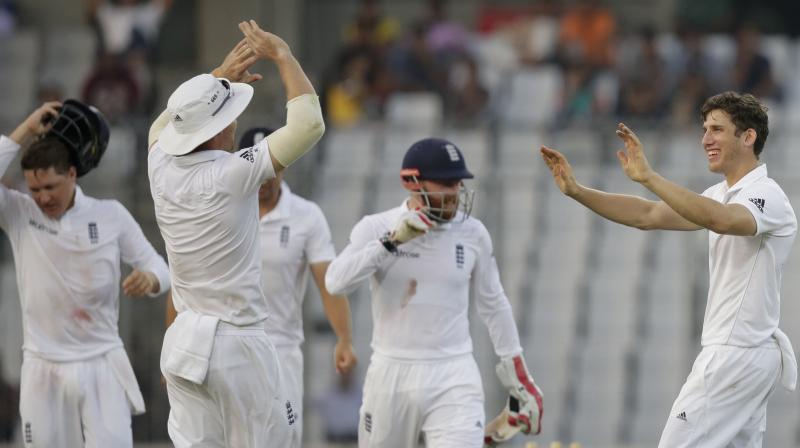 Englands Zafar Ansari, right, celebrates with his teammates after the dismissal of Bangladeshs Mahmudullah during the second day of their second cricket test match in Dhaka, Bangladesh (Photo: AFP)