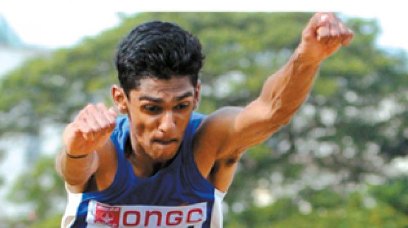 Sreeshankar M. of Palakkad takes record gold in U-18 boys long jump in the state junior athletics championships at the Maharajas College Ground in Kochi on Saturday (Photo: ARUNCHANDRA BOSE)