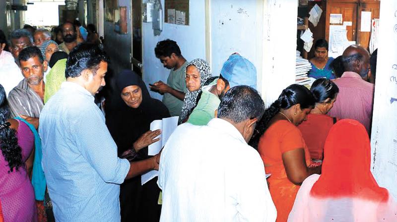 Ration card holders queue up in front of the city rationing office at Kozhikode civil station on Saturday (Photo: DC)
