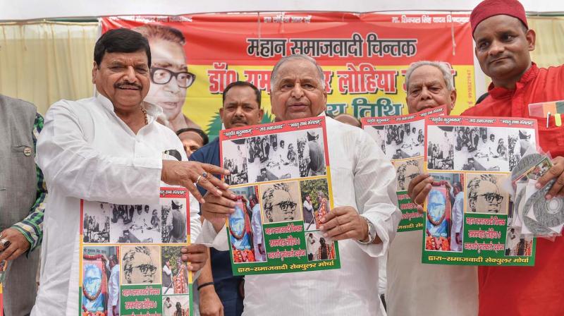 Samajwadi Party founder Mulayam Singh Yadav with his brother and Samajwadi Secular Morcha founder Shivpal Singh Yadav during a function on the birth anniversary of Dr Ram Manohar Lohia, at Lohia Trust in Lucknow.