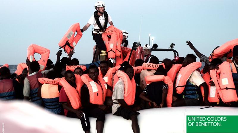 The picture -- published online and in newspapers, according to the NGO -- showed migrants in a dinghy wearing red life vests with the logo \United Colors of Benetton\ at the bottom. (Photo: @benetton/Twitter)