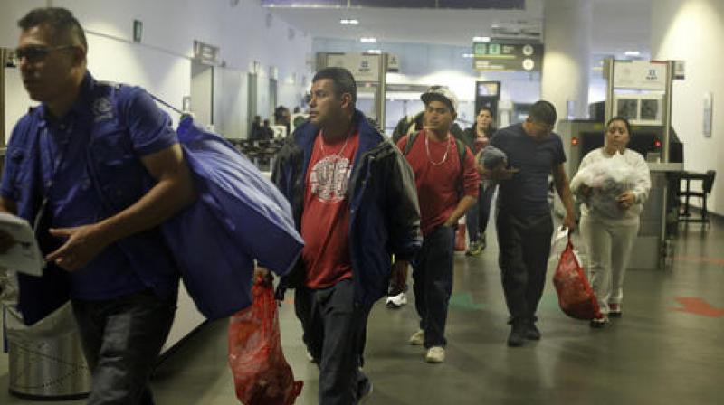 Mexican citizens arrive to the airport in Mexico City after being deported from the US. (Photo: AP)