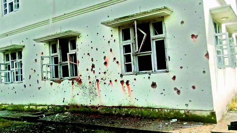 Marks of mortar shells are seen on the wall of Chakan Da Bagh building after shelling in Poonch district in Jammu and Kashmir on Monday. (Photo: PTI)