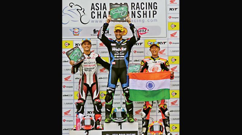 Anthony West (centre), winner of the SuperSport 600 race, is flanked by second-placed Md Zaqhwan Zaidi (left) and Taiga Hada at the FIM Asia Road Racing Championship at the MMRT in Chennai on Saturday.