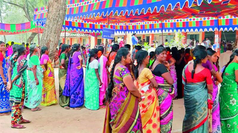 women voters queue up in Siripuram village under Madhira mandal on polling day (Photo: DC)