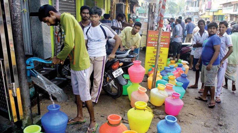 Youngsters standing in queue to fetch drinking water using a hand pump in Mylapore on Wednesday. (Photo: DC)