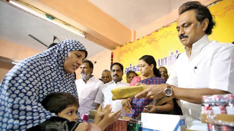 Opposition leader  M. K. Stalin  distributes relief  materials  to people in Kolathur on Wednesday (Photo: DC)