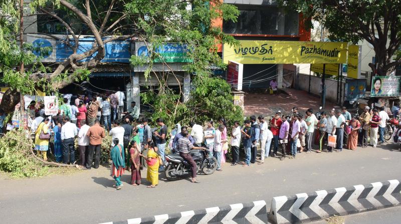 Chennai residents stand in a serpentine queue outside an ATM in Ayanavaram on Wednesday. (Photo: DC)