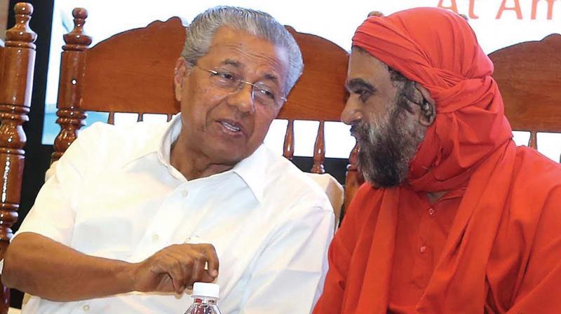 Chief Minister Pinarayi Vijayan and Swami Purnamritananda Puri at the inauguration of the high precision radiation therapy at Amrita Institute of Medical Sciences in Kochi on Saturday. (Photo: DC)