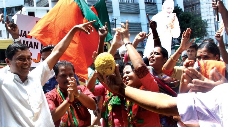 BJP workers in Kochi celebrate their partys victory in Assembly elections in UP and other states on Saturday. (Photo: DC)
