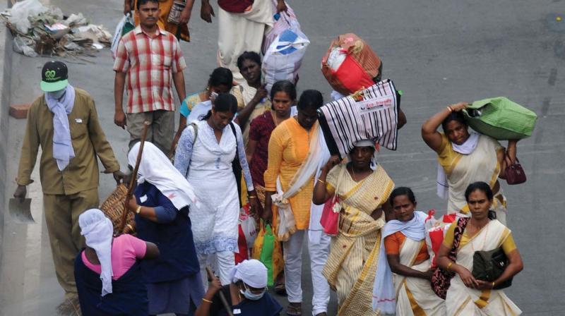 Corporation workers clean up the streets as devotees return homes after offering Pongala, in Thiruvananthapuram on Saturday. (Photo:  DC)