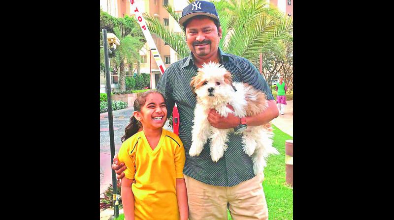 Madhav Reddy with his daughter and dog.