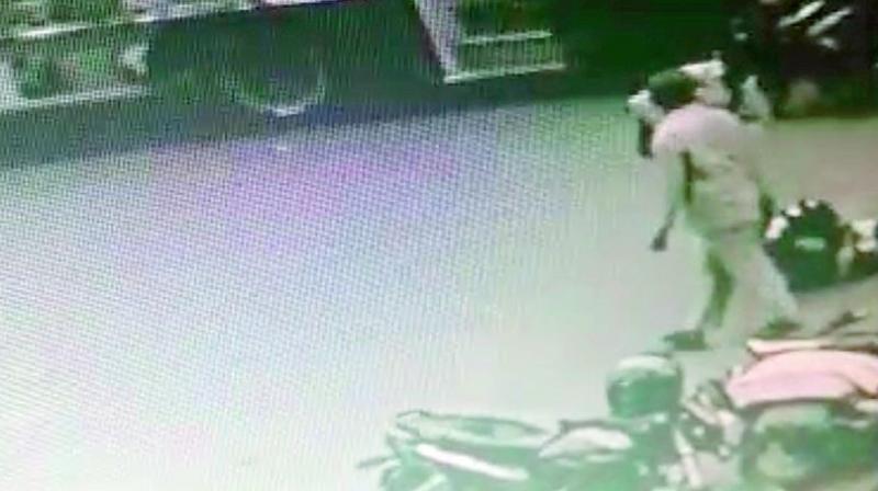 CCTV grab of the father attacking his daughter on Wednesday.