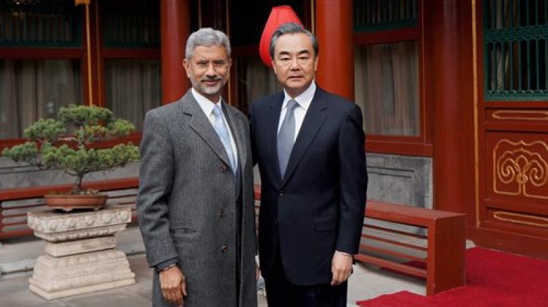 Foreign Secretary, S. Jaishankar with Chinese Foreign Minister Wang Yi before a meeting in Beijing on Wednesday. (Photo: PTI)