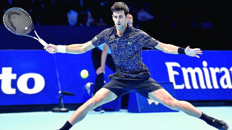 Serbias Novak Djokovic returns to Marin Cilic of Croatia in their mens singles round-robin match of the ATP World Tour Finals in London on Friday. (Photo:  AFP)