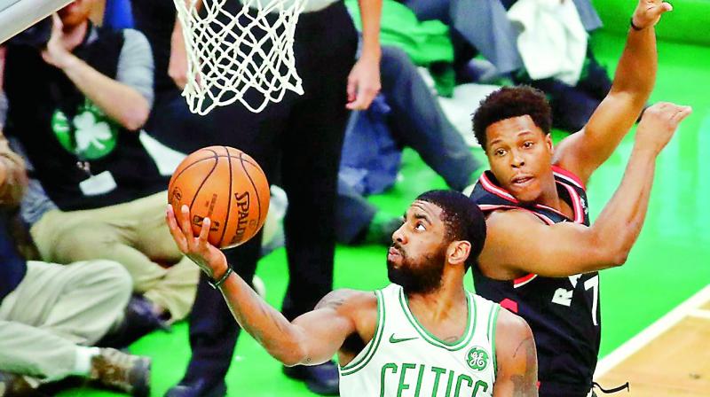 Boston Celtics Kyrie Irving (left) drives to the basket against Kyle Lowry of the Toronto Raptors in their NBA game at TD Garden in Boston, Massachusetts, Friday (Photo:AFP)