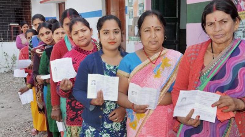 Women stand in line to cast their vote during Uttarakhand assembly election in Haridwar. (Photo: PTI)