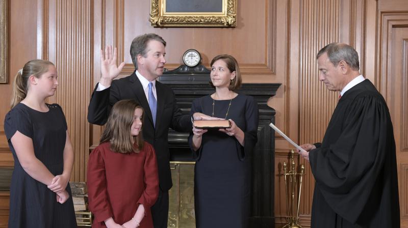 Chief Justice John Roberts, right, administers the Constitutional Oath to Judge Brett Kavanaugh in the Justices Conference Room of the Supreme Court Building in the presence of his family. (Photo: AP)