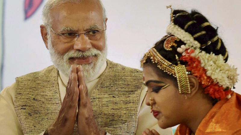 Prime Minister Narendra Modi meeting a performer at an event organised at the residence of Union I&B minister M. Venkaiah Naidu on the occasion of Telugu New Year Ugadi in New Delhi on Sunday. (Photo: PTI)