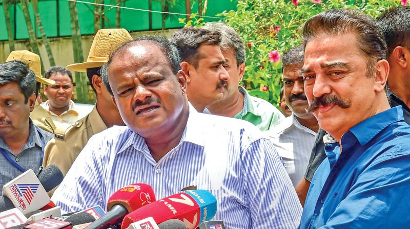 Karnataka Chief Minister H.D. Kumaraswamy and Makkal Needhi Maiam chief Kamal Haasan address the media after their meeting in Bengaluru on Monday. (Photo: AP)