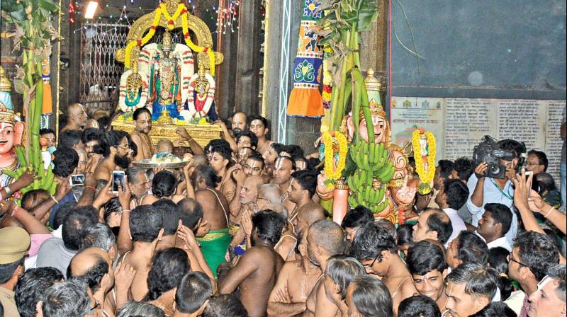 Lord Parthasarathy Swamys idol being brought through the Paramapadavasal (gateway to heaven) during the auspicious Vaikunta Ekadasi celebrations at the Sri Parthasarathy Swamy temple, which is among the 108 Divya Desams, in the city on Sunday. (Photo: DC)