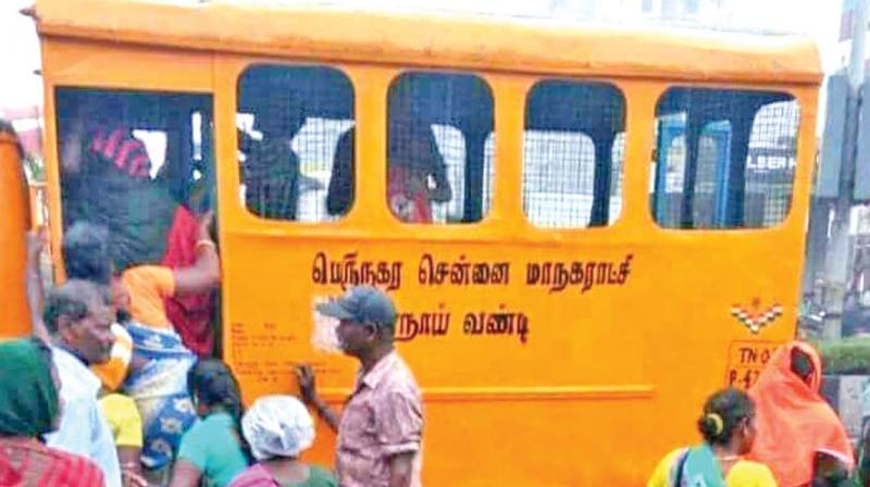 The picture, believed to be clicked during the ongoing bus strike and reportedly taken in Arumbakkam, shows men and women boarding the dog vehicle while a few others wait for their turn.