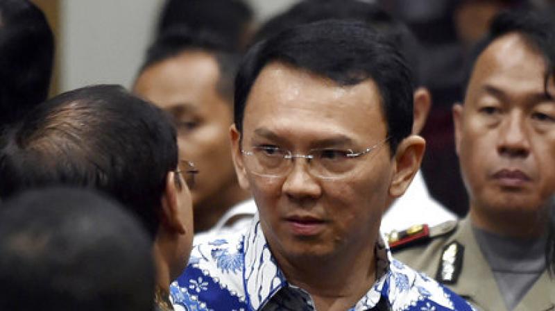 Jakarta Governor Basuki \Ahok\ Tjahaja Purnama, center, talks to his lawyers after his sentencing hearing at a court in Jakarta (Photo:AP)