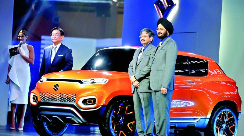 Maruti Suzuki MD and CEO Kenichi Ayukawa (left), senior executive director, marketing and sales, R.S. Kalsi (right) and senior executive director (engineering) C.V. Raman during the launch of Concept FutureS at the Auto Expo 2018 in Greater Noida on Wednesday. (Photo: AP)