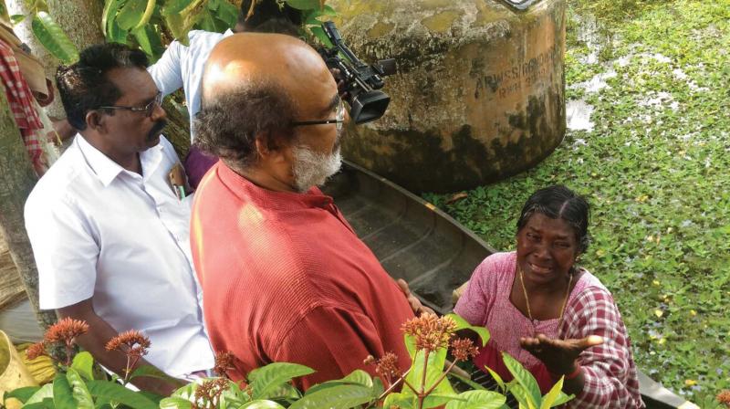 Finance minister T.M. Thomas Isaac listens to an  R Block resident during his visit on Saturday. (Photo: DC)