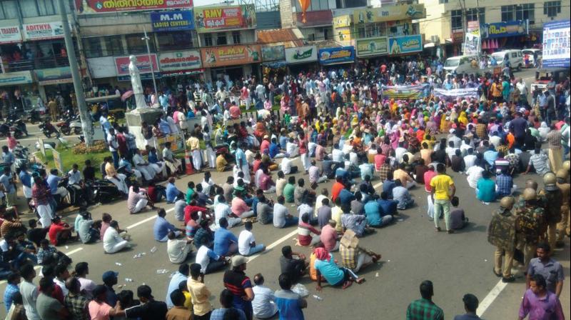 Fishermen protesting at Neyyatinkara on Saturday.