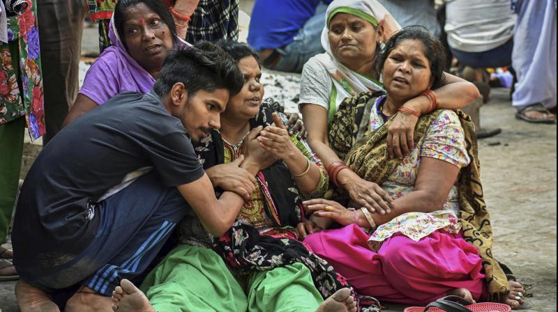 Relatives during the cremation of a victim of Fridays train accident, in Amritsar, on Sunday. (Photo: PTI)