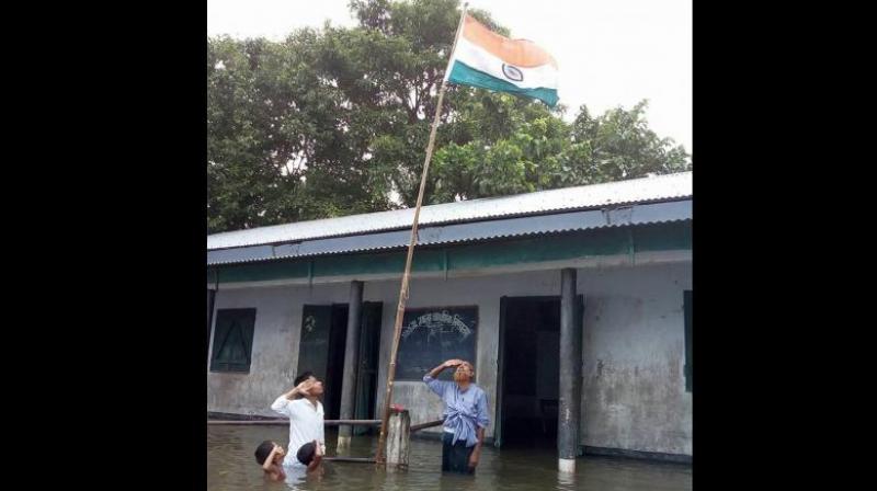 Tajen Sikdar, the head teacher of the primary school in Dhubri district, who had stood in the flood water with Haider Ali Khan and two others, said on Thursday that Haiders name was not in the draft NRC. (Photo: Facebook/@Mizanur Rahman)