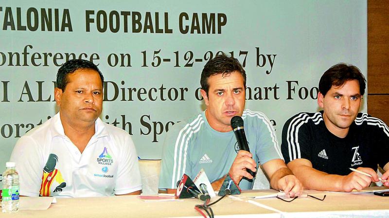 Albert Aliau (centre), director of Smart Football in Salou, Catalonia, speaks to reporters in Hyderabad on Friday.