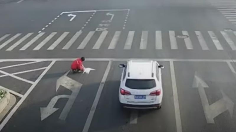 Chinese man frustrated by traffic repaints lines on road; fined $150