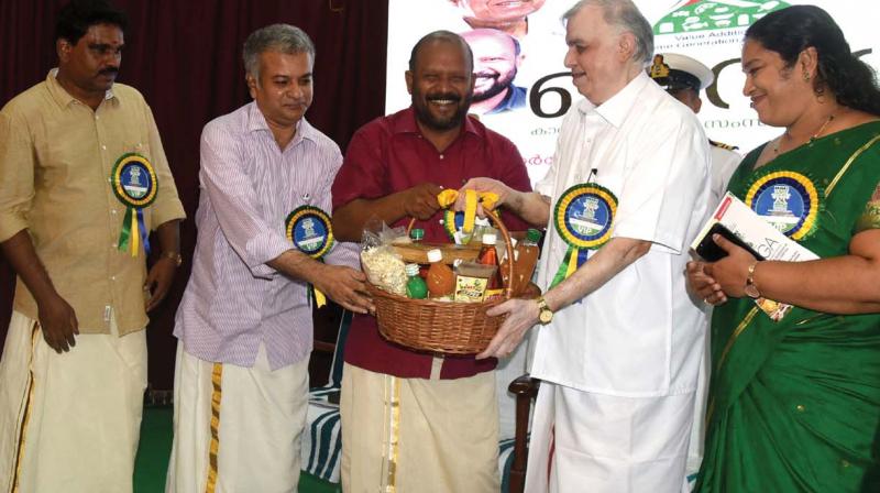 Agriculture minister V.S. Sunilkumar presents a basket of value-added agricultural products to governor P. Sathasivam during the inauguration of the seminar and exhibition on Value Addition for Income Generation in Agriculture in Thiruvananthapuram on Thursday. Agriculture director Biju Prabhakar, production commissioner Raju Narayanaswami and others look on. (Photo:  DC)