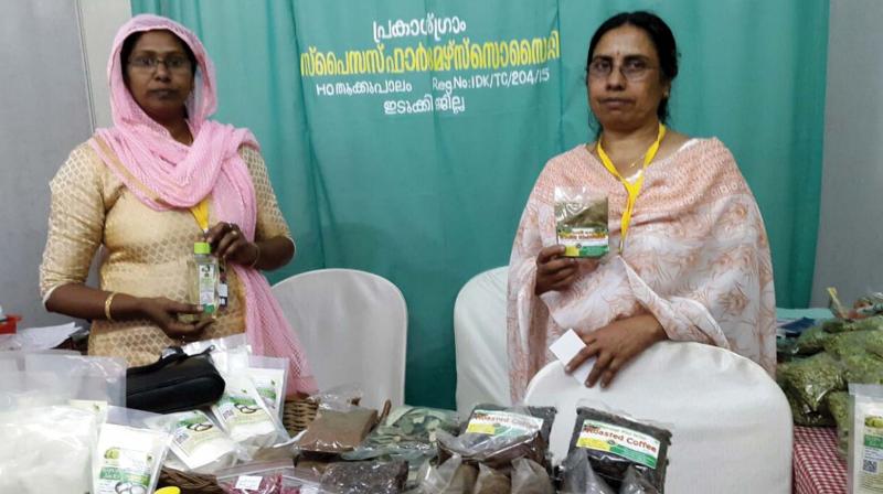 Lalitha and Abida from Kallar in Idukki with hand-made virgin coconut oil at the exhibition on Sooryakanthi grounds on Thursday. (Photo:  DC)