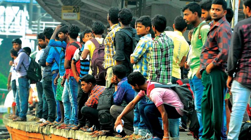 Migrant workers wait for trains at Kozhikode railway station to go back home. (Photo:  DC)